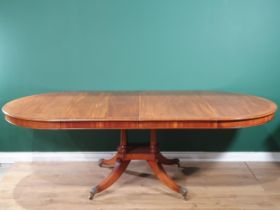 A good quality mahogany extending Dining Table crossbanded in walnut, raised on a quadruple base