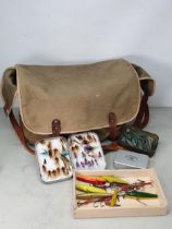 A Canvas Fishing Bag containing a Richard Wheatley Fly Tin, a Malloy Fly Tin and a quantity of