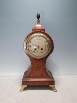 A 19th Century satinwood Mantel Clock with circular dial above inlay of vase of flowers and raised