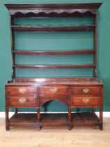 An 18th Century oak Potboard Dresser with open rack, the base fitted seven dummy spice drawers, five