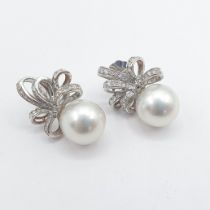 A pair of South Sea Pearl and Diamond Earrings each with large single pearl, approx 13mm, below
