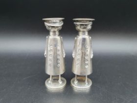 A pair of modern silver Novelty Pepperettes in the form of chauffeurs on circular bases,