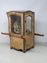 An antique Doll's Sedan Chair with fabric covering and glazed door 14in H x 7in W, with an antique