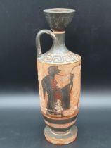 A Greek pottery Oil Flask decorated figures in black on a terra cotta ground, Greek key frieze,