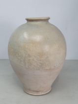 A Chinese buff pottery Vase, the top half with clear glazing, the rim slightly uneven, possibly Tang