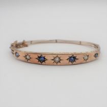 A Sapphire and Diamond hinged Bangle the front pavé-set three old-cut diamonds and four round