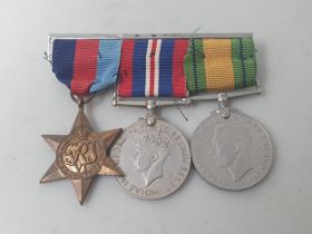 Three; WWII Trio including 1939-45 Star, Defence and War Medals, unnamed as issued