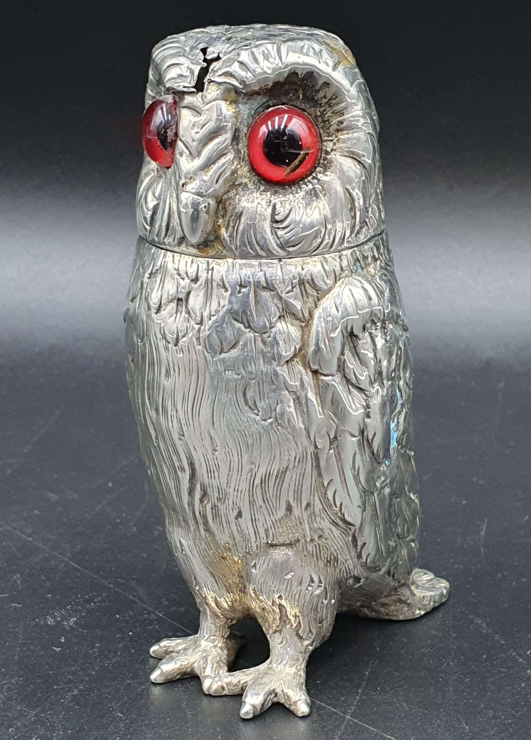 A Victorian silver large owl Pepperette with coloured glass eyes, London 1862, maker: probably