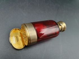 A Victorian silver-gilt mounted red glass Scent Bottle/Vinaigrette with finely scroll pierced and