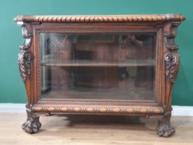 A carved walnut Display Cabinet with bevelled glazed front panel flanked by acanthus leaf pillars