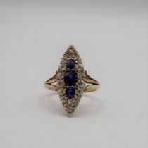 A Sapphire and Diamond Cluster Ring the marquise shaped plaque pavé-set three graduated round