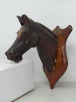 A folk art carved and gesso Model of a neck mounted Horse's Head on shield 7 1/2in H