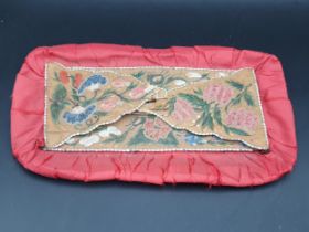 A 19th Century North American Indian needlework and beadwork on red silk and bark bag with floral