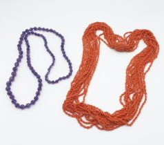 An Amethyst graduated faceted bead Necklace and a coral coloured bead rope Necklace