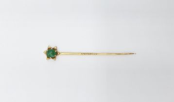 A gold Stick Pin (tests as 22ct) set oval jadeite cabochon in star frame, approx 3.60gms, approx