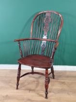 A 19th Century large yew Windsor Elbow Chair with pierced splat back & crinoline stretcher.