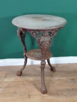 A cast iron Garden Table with circular wooden top with masks to the supports and with lower tier,