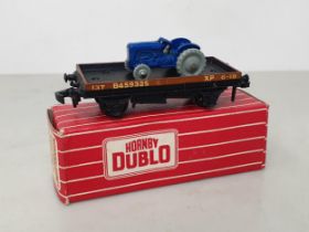 A boxed Hornby Dublo 4849 Export Low-sided Wagon with tractor, unused. Wagon and tractor in mint