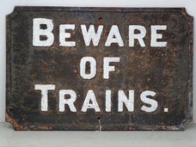 A cast iron 'BEWARE OF TRAINS' Sign 21in W x 14in H