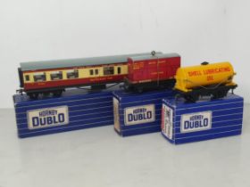 A Hornby Dublo D1 'Shell' Tank Wagon, D1 Low-sided Wagon and D20 Restaurant Car in over sticker 3-