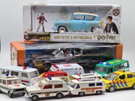 A boxed NJCroce Batmobile, a boxed Harry Potter Ford Anglia and a tray of unboxed diecast Ambulances