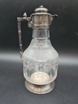 A Victorian silver mounted and lidded cut glass Claret Jug with leafage engraved frieze, mask finial