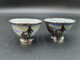 A pair of silver mounted small enamel Bowls decorated African tribal figures with shields, floral