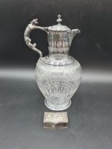 A plated mounted and lidded glass Claret Jug with griffin handle, and a small white metal Box