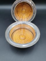 A pair of George V circular Coasters with gadroon rims, turned wooden bases, engraved inscription,