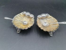 A pair of Victorian silver scallop shape Salts on dolphin supports, Birmingham 1873, maker: George