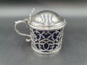 A George III silver pierced Drum Mustard Pot with domed lid having pierced thumb piece, blue glass