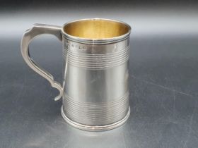 A George IV silver Christening Mug of tapering form with reeded bands engraved initials M.A.C,
