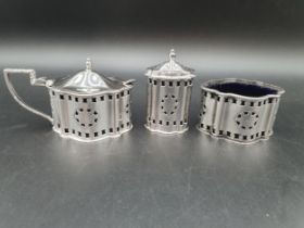 An Elizabeth II silver three piece Condiment Set of pierced shaped oval form with rosette friezes