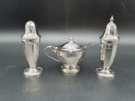 A George V silver three piece Condiment Set of panelled circular form, Sheffield 1934/5, plus Spoon