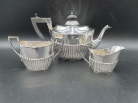 A Victorian silver three piece Tea Service of oval semi-fluted form engraved initials, Birmingham