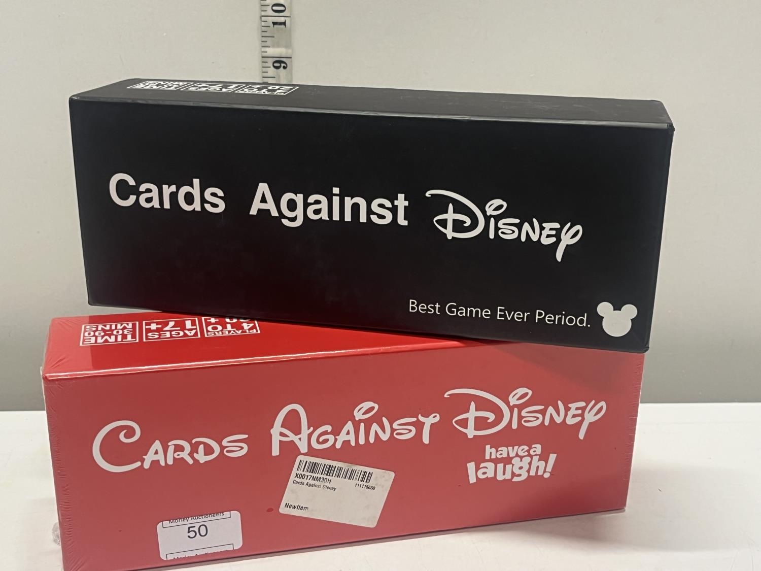 A new sealed box of cards against Disney and one other