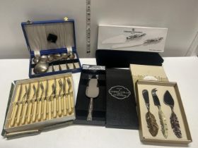 A selection of cased cutlery including Laura Ashley and a new international silver company cake