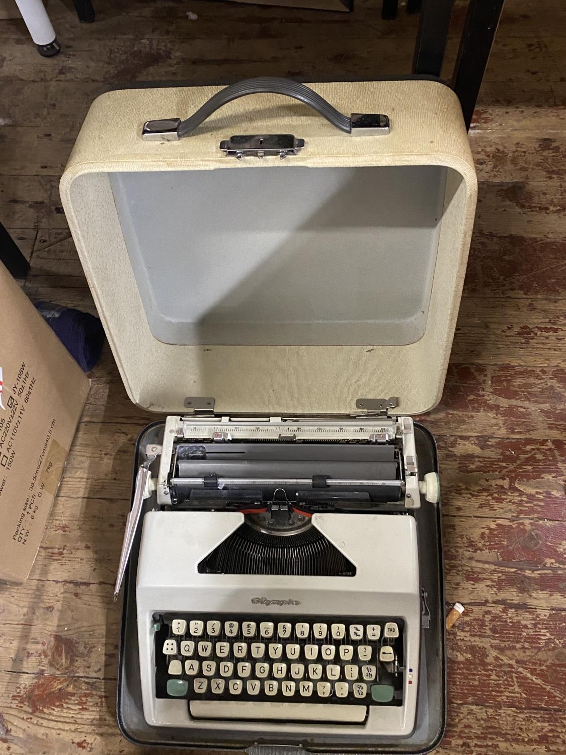 A vintage Olympia portable typewriter, shipping unavailable