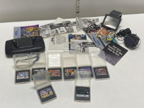 A Sega Game Gear console with chargers & eight assorted games and accessories (untested)