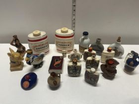 A selection of empty vintage whisky and brandy miniatures with stoppers