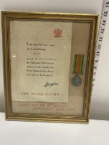 A WW2 home guard certificate and defence medal, framed