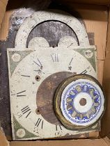 A box of assorted antique clock face dials