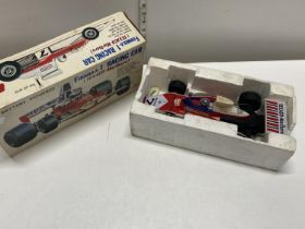 A boxed vintage battery powered Formula 1 racing car