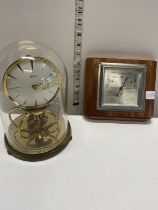 A vintage glass dome case Kundo clock and a barometer