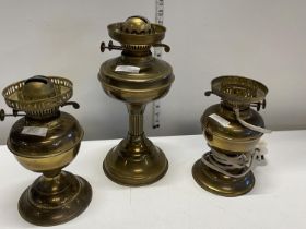 Another three brass oil lamps one converted for electric use