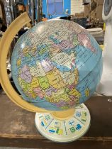 A vintage metal globe on stand