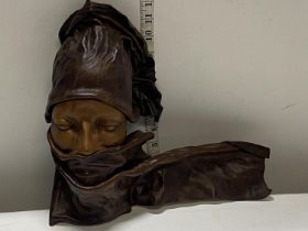 A unusual leather wall hanging mask
