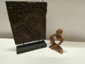 A hand carved wooden Budda plaque and one other