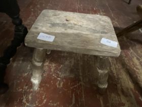A antique wooden four legged stool.