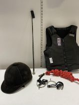 A selection of horse riding safety equipment etc including crop